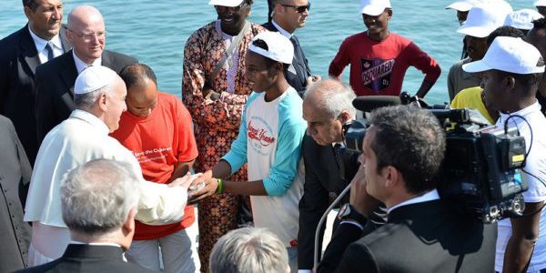pope francis greets migrants